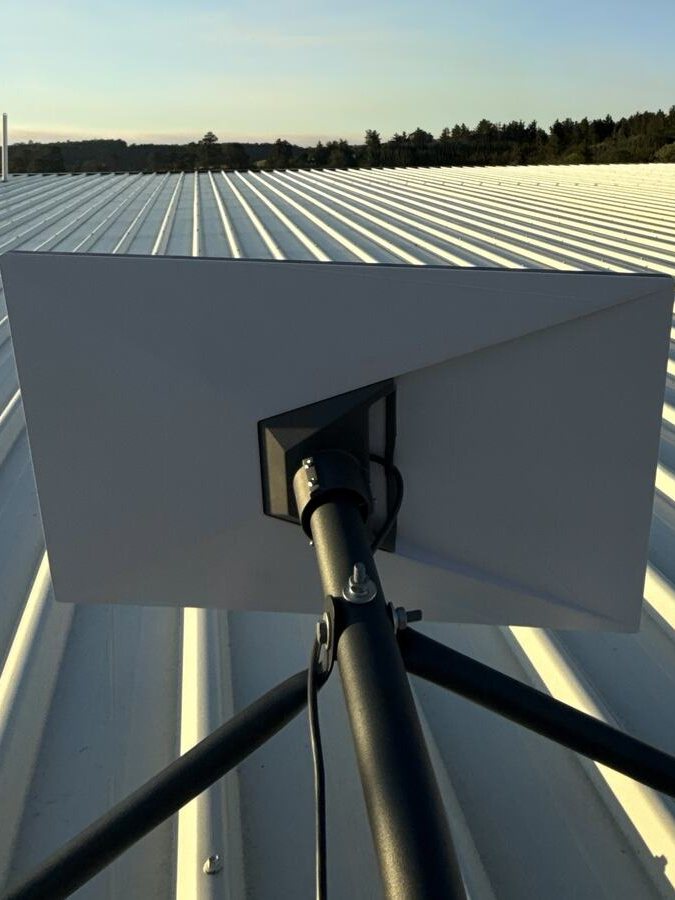 Roof-mounted Starlink dish at golden hour on a Colorbond roof in the South West of WA